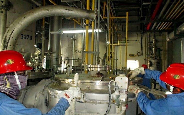 Technicians opening a large reactor for internal inspection and maintenance